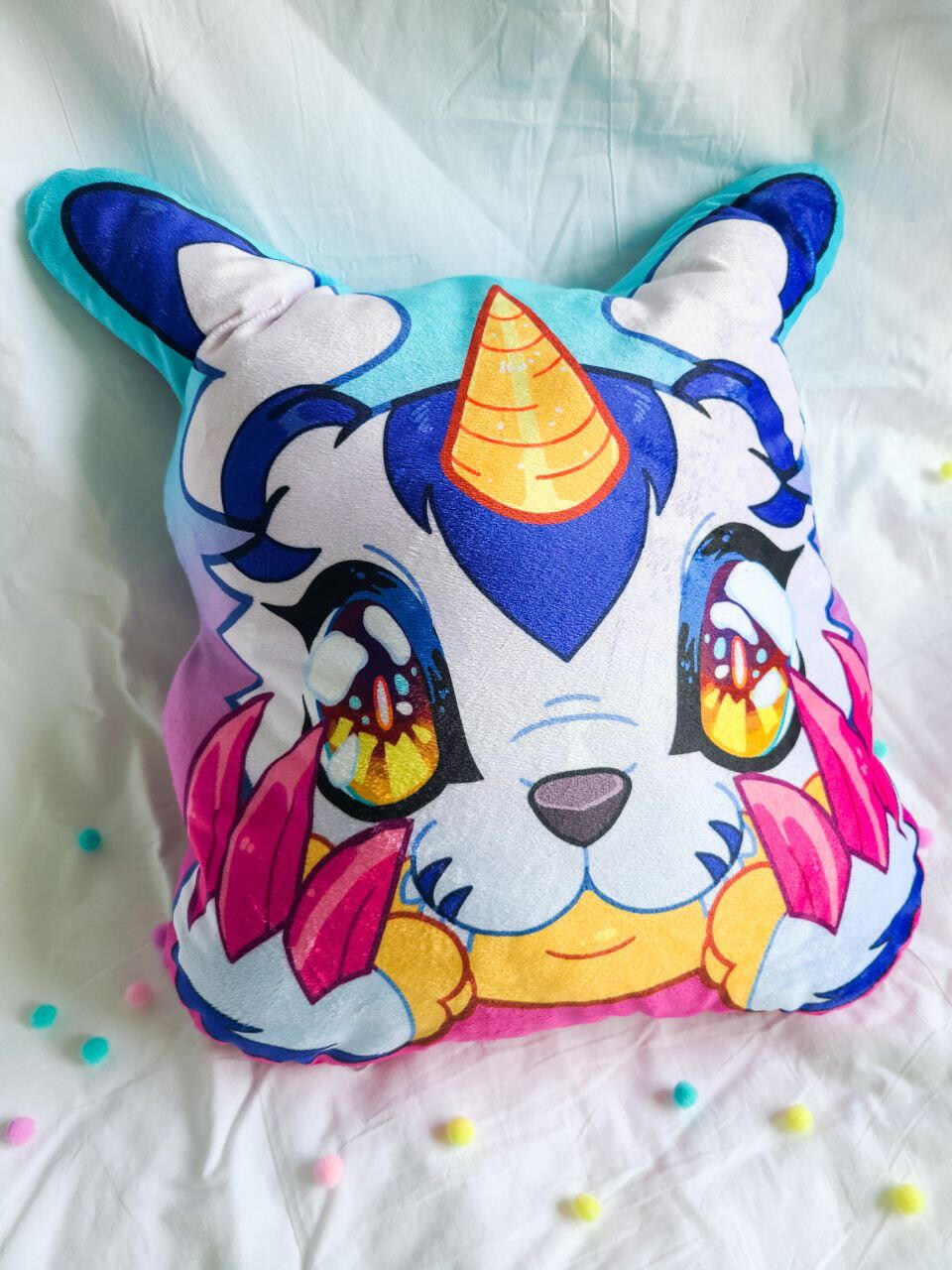 A pillow in the shape of a dog like creature on a gradient background.