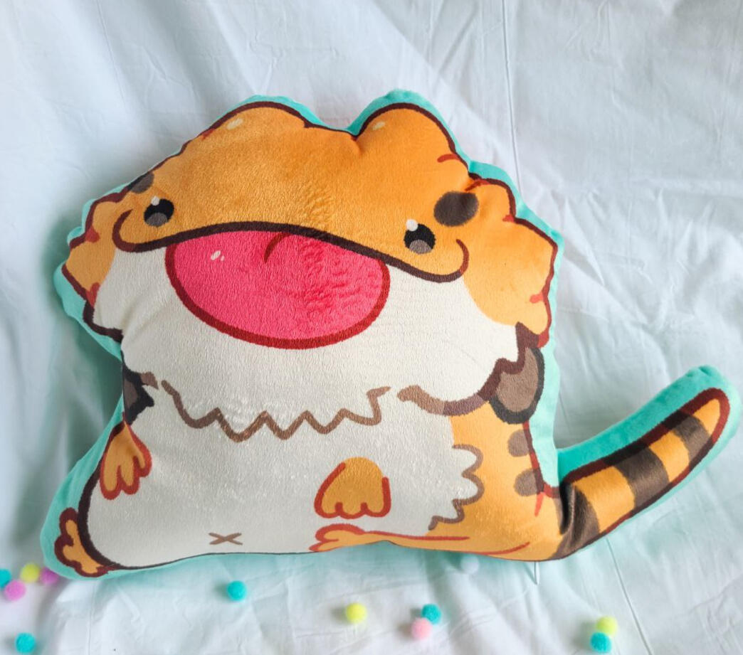A pillow in the shape of a dog like creature on a gradient background.